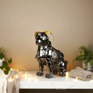 Metal wall sculpture decor ideas for modern homes — gunmetal fluted lamp on a console beneath a dark metal wall sculpture in a contemporary living room