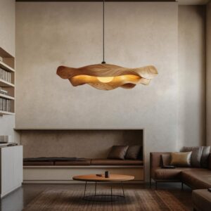 Coffee table sculpture display ideas for living room — Affogato brass ceramic lamp on a side table beside a coffee table styled with sculpture, books, and organic accessories