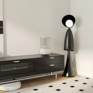 Textured wall art sculpture living room — meadow ombre ceramic lamp on a console beside a three-dimensional textured wall art installation