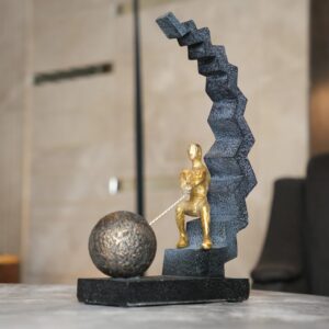 How to carve stone sculpture for home decoration — natural beige lamp on a studio console beside a soapstone carving in progress with stone carving tools
