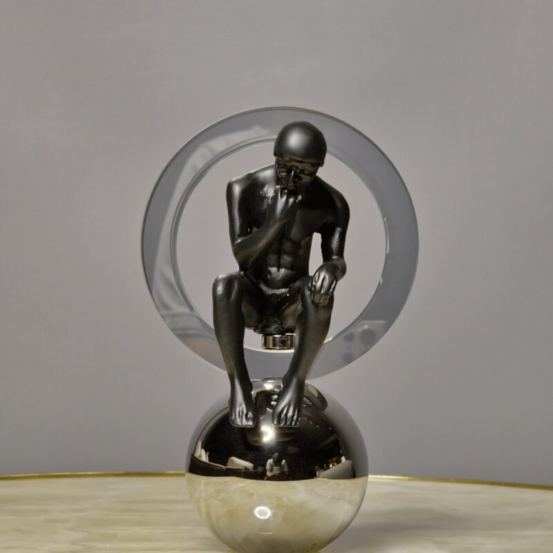 Sculpture finishing techniques for smooth professional results — slim modern accent lamp in a studio beside sculptures at different surface quality stages