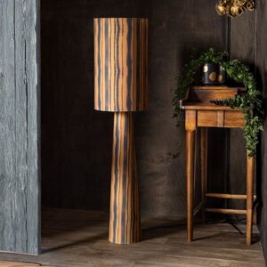 Tripod floor lamp styling — amber organic floor lamp as companion to tripod in a warm-palette living room
