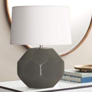Black table lamps — Aarna matte black lamp as a quiet resolved punctuation mark in a contemporary room with warm-neutral palette