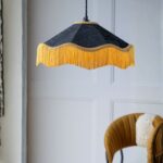 Modern chandeliers — black and gold tassel ceiling light creating contemporary glamour with textile movement