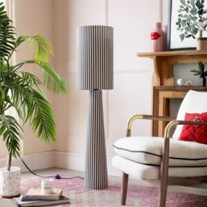 Reading floor lamp companion — amber blurred line floor lamp as ambient companion while a dedicated reading lamp handles task illumination