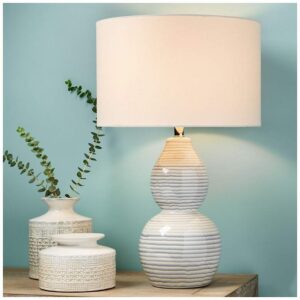 Dining room table lamp buffet — Adeline gold petal lamp as sideboard statement in a dining room with food service occupying center surface