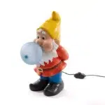 Curious gnome table lamp glowing blue on a bookshelf in a kids' room