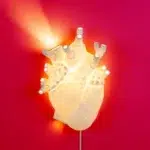 Anatomical heart wall lamp mounted above a nightstand