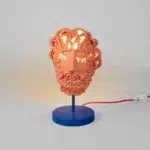 Detail / close-up Close-up of pierced beard curls glowing on the terracotta mask lamp