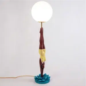 Retro table lamp — yellow diver plunging from white glass globe, teal splash base