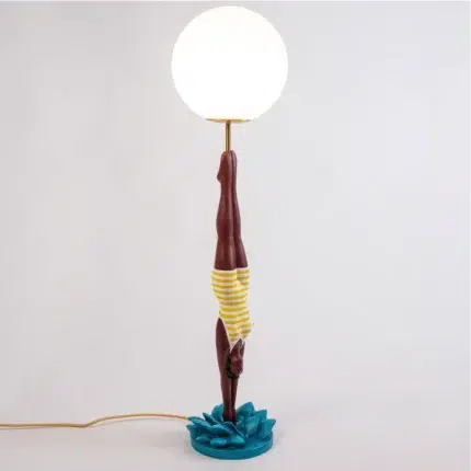 Retro table lamp — yellow diver plunging from white glass globe, teal splash base