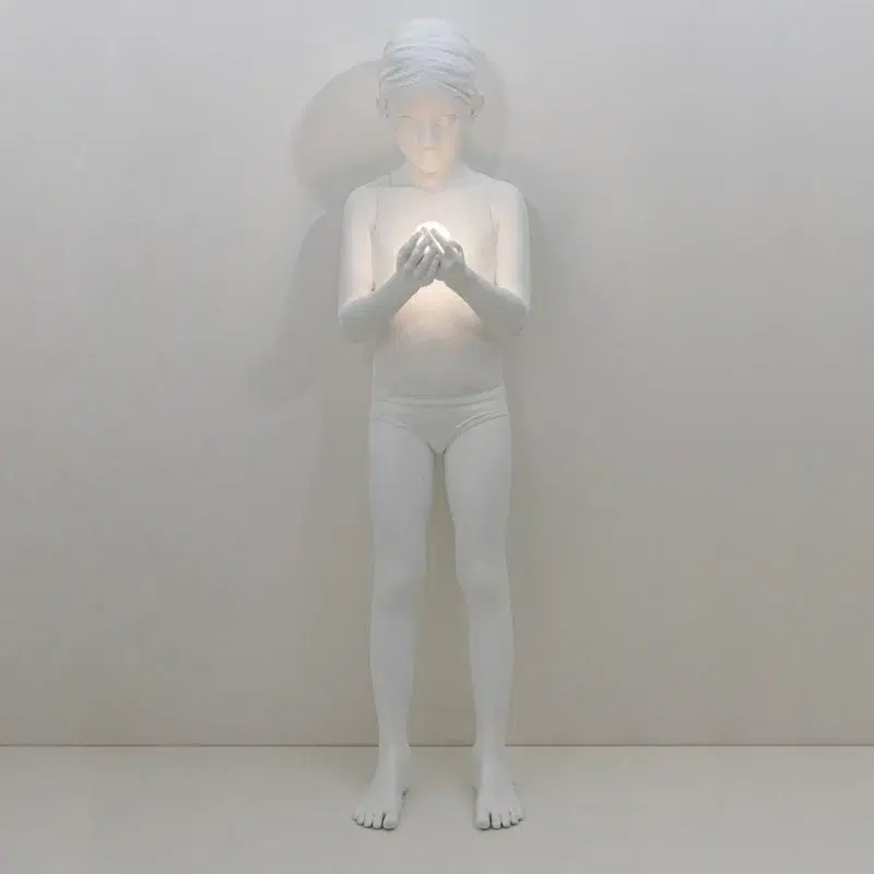 Figural floor lamp with reclining white resin figure