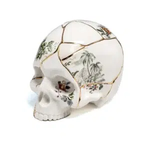 Kintsugi skull sculpture with real 24k gold seams