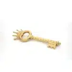 Gold power key sculpture styled on a console