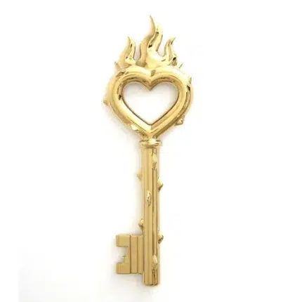 Close-up of gold passion key sculpture finish