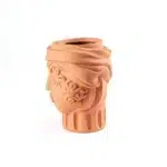 Terracotta woman vase styled on a console table