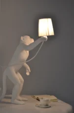 Table Lamp Monkey Standing White, shown in a living room
