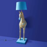 Floor Lamp Zebra Print Blue and Orange, shown illuminated in a living room setting