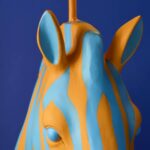 Floor Lamp Zebra Print Blue and Orange, shown illuminated in a living room setting