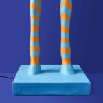 Floor Lamp Zebra Print Blue and Orange, shown illuminated in a living room setting