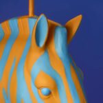 Floor Lamp Zebra Print Blue and Orange, shown illuminated in a living room setting