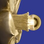 Wall Lamp Flower Gold, shown mounted in a bedroom setting