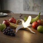 Table Lamp Banana Gold, shown on a sideboard