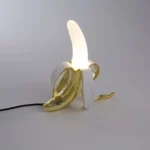 Table Lamp Banana White and Gold, shown on a sideboard