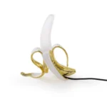 Table Lamp Banana White and Gold, shown on a sideboard