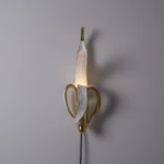 Wall Lamp Banana Gold, shown mounted in a living room