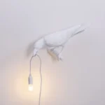 Table Lamp Raven White Looking Left, shown on an entryway console