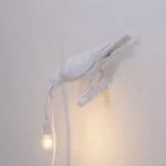 Table Lamp Raven White Looking Left, shown on an entryway console
