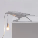 Table Lamp Raven White Playing, shown on an entryway console