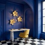 Wall Lamp Flower Gold, shown mounted in a bedroom setting
