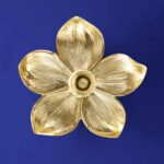 Wall Lamp Flower Gold, shown mounted in a bedroom setting