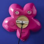 Wall Lamp Flower Magenta, shown mounted in a bedroom setting