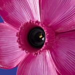 Wall Lamp Flower Magenta, shown mounted in a bedroom setting