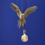 Ceiling Lamp Parrot Gold, shown mounted over a dining table