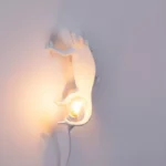 Wall Lamp Chameleon Climbing, shown mounted in a living room
