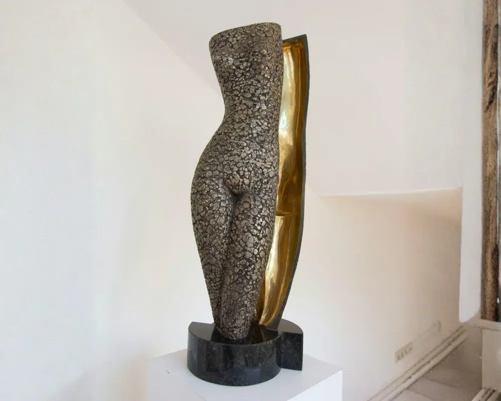 Modern sculptural decorative vase with gold accents in a minimalist interior