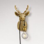 Wall Lamp Deer Gold, shown mounted in a nursery or hallway