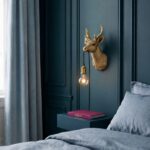 Wall Lamp Deer Gold, shown mounted in a nursery or hallway