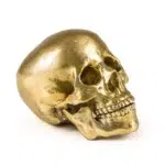 Gold human skull sculpture in cast aluminum