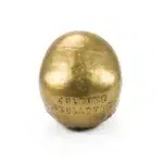 Side view of gold human skull sculpture