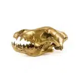 Gold wolf skull sculpture styled on a shelf