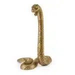 Gold snake sculpture styled on a console