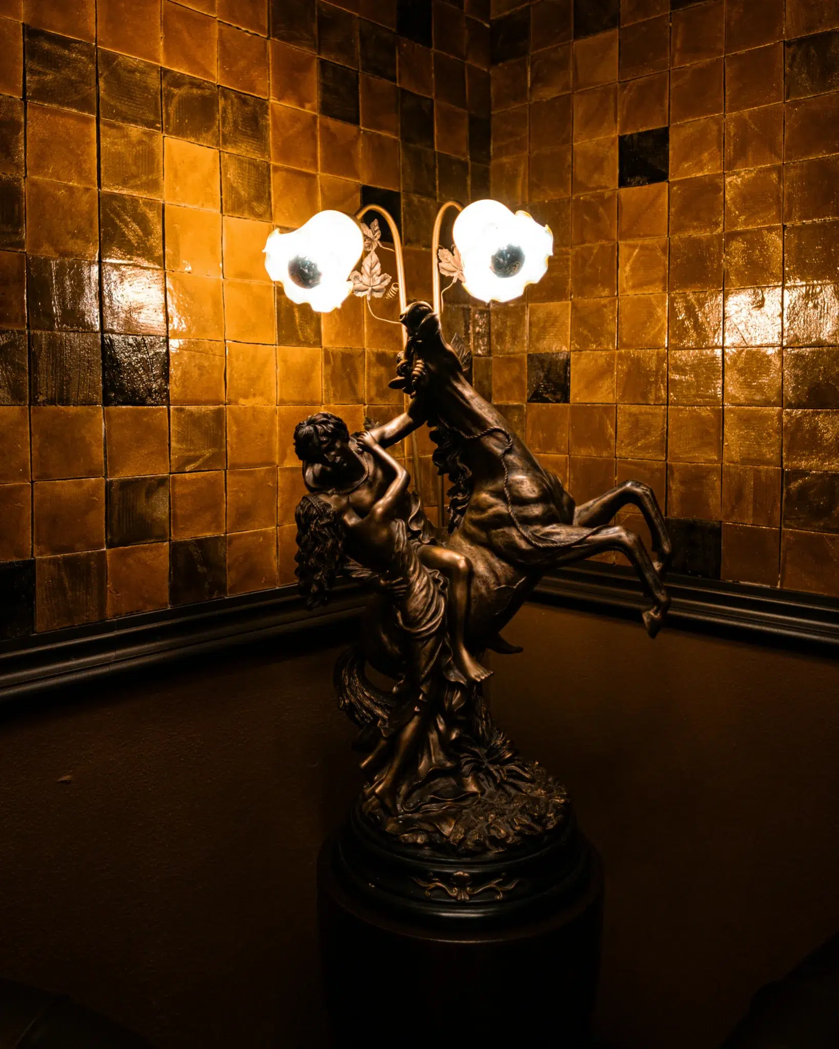 Decorative bronze floor lamp sculpture displayed in an elegant interior
