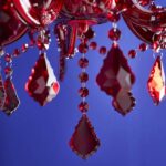 Glass Chandelier Aurora Red, shown mounted over a dining table