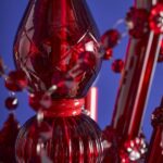 Glass Chandelier Aurora Red, shown mounted over a dining table