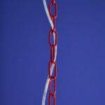 Glass Chandelier Aurora Red, shown mounted over a dining table